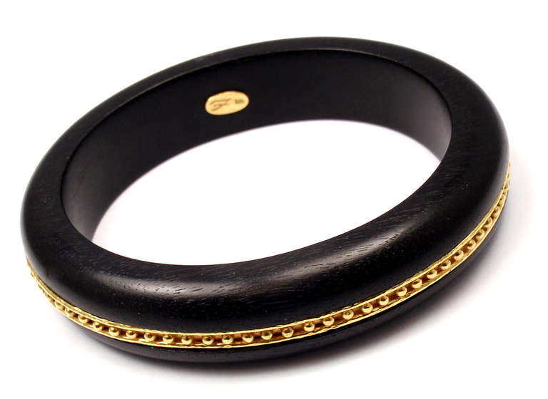 18K Yellow Gold Ebony Wood Bangle Bracelet by Elizabeth Locke. 

Details: 
Length: 7