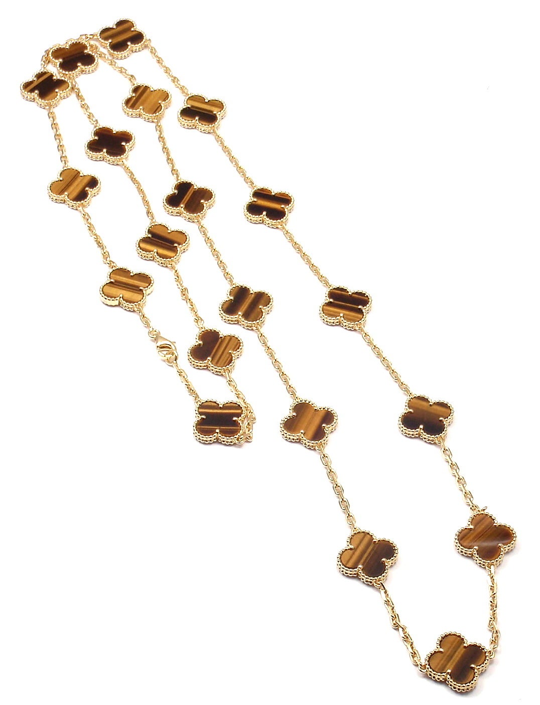 18k Yellow Gold Alhambra Twenty-Motif Tiger’s Eye Necklace by 
Van Cleef & Arpels. 
With 20 motifs of Tiger’s Eye Alhambra stones, 15mm each.

Details: 
Length: 33