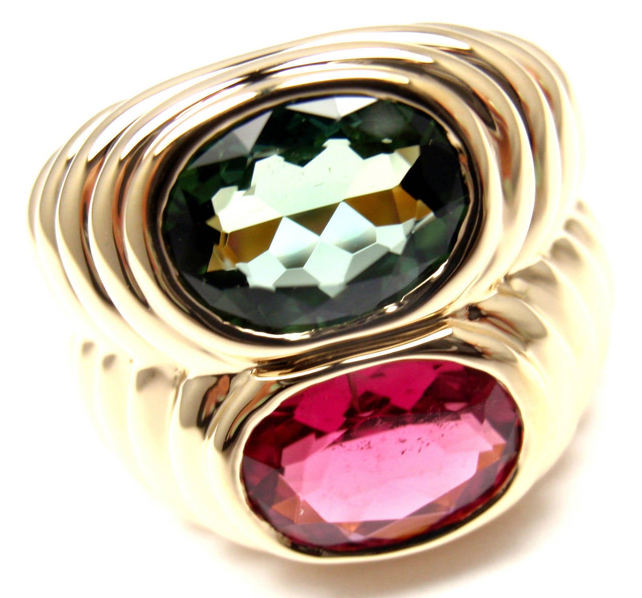 18k Yellow Gold Pink And Green Tourmaline Ring By Bulgari.
With 1 oval pink tourmaline 9mm x 7mm
1 oval green tourmaline  9mm x 7mm

Details:
Ring Size: 6 (resize available)
Width: 16mm
Weight: 14.3 grams
Stamped Hallmarks: Bvlgari