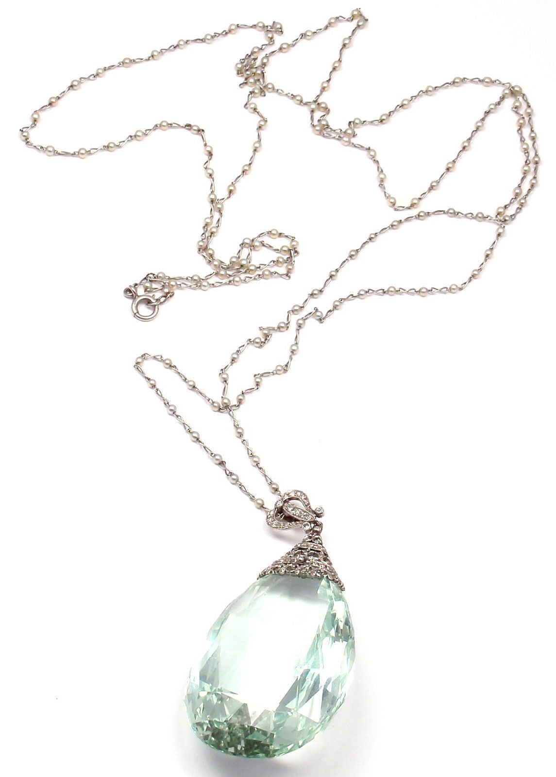 Estate 18k White Gold Diamond Large 167ct Aquamarine Pendant Necklace.
With 1 pear shape large aquamarine 48mm x 32mm total weight approx. 167ct
152 round seed pearls 2.5mm each
round single cut diamonds

Measurements:
Chain: Chain: Length