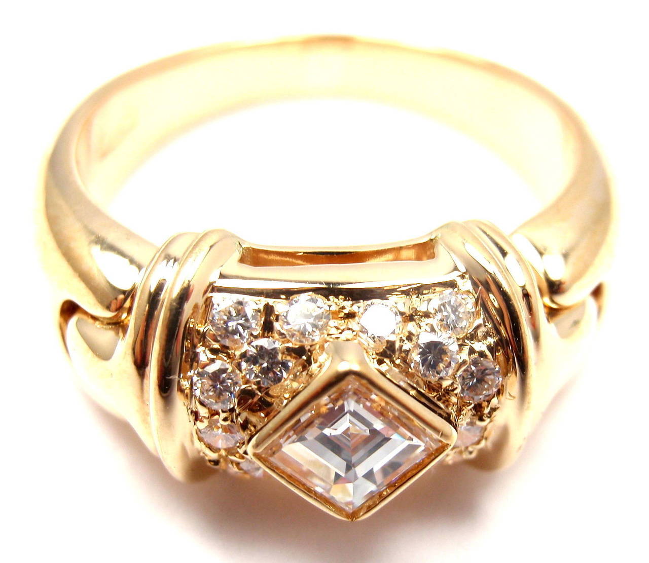 18k Yellow Gold Diamond Ring by Bulgari. 
With 16 Round Brilliant cut Diamonds & 1 princess cut diamonds approximately weighing .45cts With G Color And VS1 Clarity

Details:
Ring size: 5.5(can be resized)
Width: 8mm
Weight: 7.3 grams
Stamped
