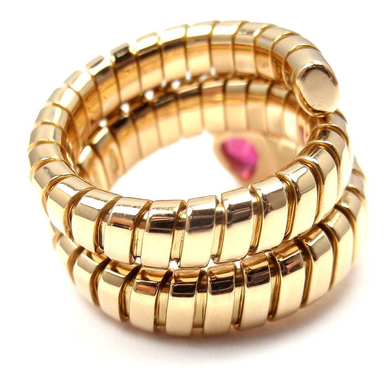 18k Yellow Gold Ruby Coil Snake Ring by Bulgari. With One Pear-Shaped Ruby Stone: 6mm x 4mm.

Details:
Ring Size: 6-9 (the ring stretches)
Weight:  15.2 grams
Width: 9.0mm - 17.0mm at widest point, stone is 6mm x 4mm
Stamped Hallmarks: