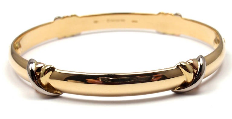 18k Tri-Color Gold Love Trinity Bangle Bracelet by Cartier. 
This bracelet comes with a Cartier box and an original screwdriver.

Details:
Size: 16
Weight: 26.4 grams 
Width: 8mm
Stamped Hallmarks: Cartier 750 16 D36242 1995

*Free Shipping