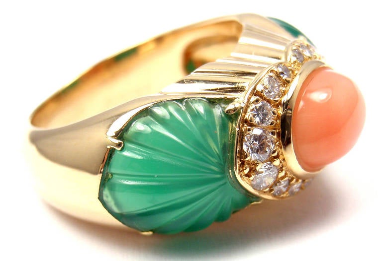 18k Yellow Gold Diamond, Green Chalcedony, Pink Coral Ring. With 16 brilliant round cut diamonds at .25ct total weight. VS1 clarity, H color. 2 carved green chalcedony and 1 gorgeous oval pink angle coral. This ring comes with its original Cartier