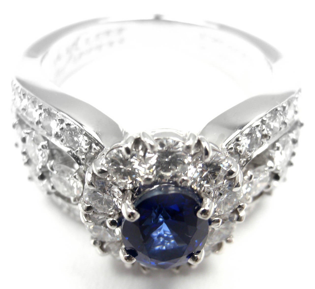 Platinum Diamond & Sapphire Ring by Van Cleef & Arpels.
With 44 round brilliant cut diamond VVS1 clarity, E color total weight 2.25ct
1 oval sapphire stone approx. 1ct

Details:
Ring Size: 5.5 (resizable)
Width: 11mm
Weight: 10.7