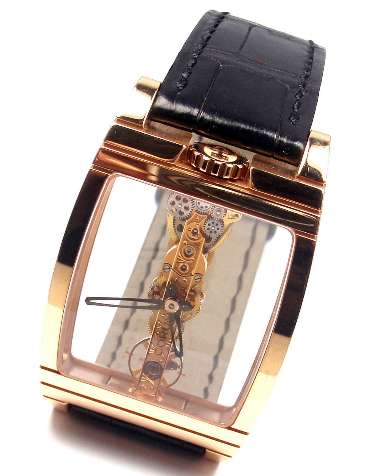 18k Rose Gold Golden Bridge Mens Watch Reference 113.750.55 by Corum

Details:
Brand: Corum
Model: Golden Bridge
Model Number: 113.750.55
Case: 18k rose gold curved tonneau case with sapphire crystal panels on both sides to view with visible