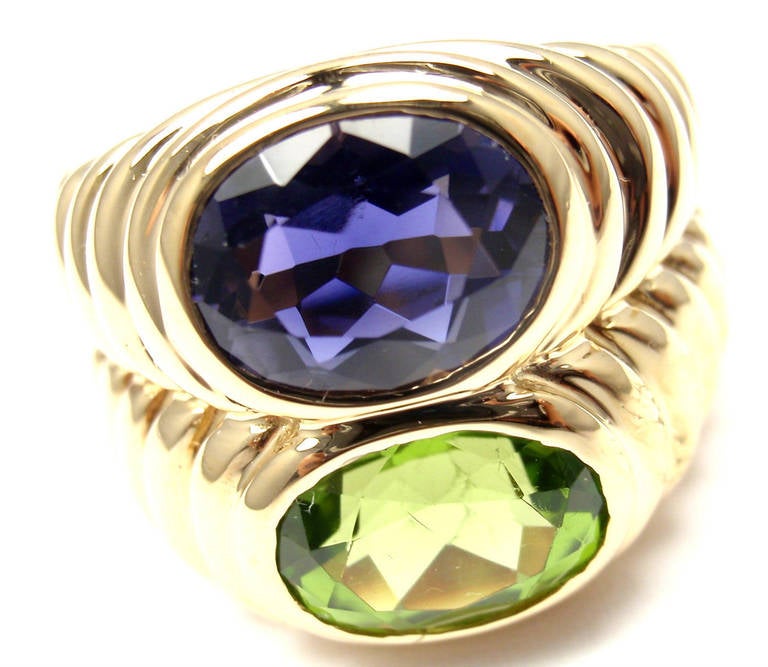 18k Yellow Gold Peridot And Iolite Ring By Bulgari. 
With 1 Oval Peridot 8mm x 10mm
1 Oval Iolite 8mm x 10mm

Details: 
Ring Size: 6 (resize available)
Width: 17mm
Weight: 16.1 grams
Stamped Hallmarks: Bvlgari 750 
*Free Shipping within the