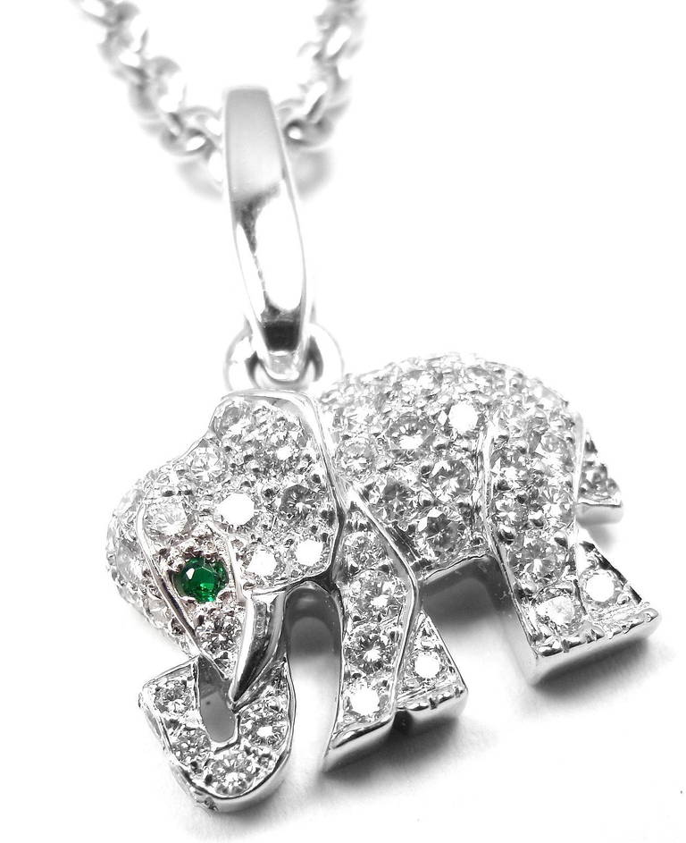 18k White Gold Diamond & Emerald Pendant Necklace by Cartier. This necklace comes with an original Cartier box. With 68 round brilliant cut diamonds, VS1 clarity, G color. Total Diamond Weight: 1CT. One round emerald stone. 

Details: 
Chain