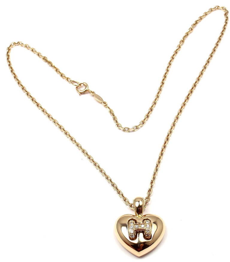 18k Yellow Gold Diamond H Heart Pendant Necklace by Hermes. With 12 Round Brilliant Cut Diamonds, VS1 Clarity, G Color. Total Diamond Weight: .25CT. 

Details: 
Length: 15