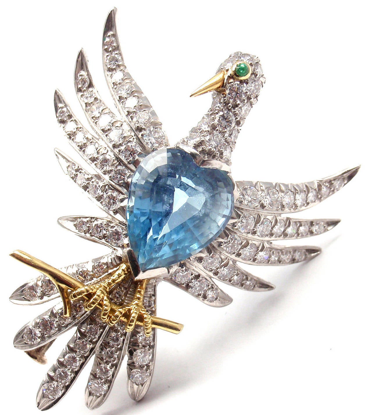 Platinum Diamond Aquamarine Phoenix Bird Brooch/Pin by Jean Schlumberger for Tiffany & Co.
With 89 round brilliant cut diamonds VS1 clarity, G color total weight approx. 1.7ct
1 aquamarine 12mm x 10mm approx. 7.85ct
1small round emerald

This