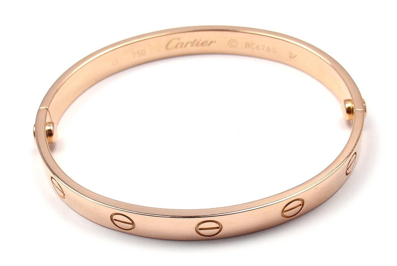18k Rose Gold LOVE Bangle Bracelet by Cartier. Size 17. 

This beautiful Cartier Love Bangle comes with an original Cartier box, Cartier service certificate and a Screwdriver.

Details:
Weight: 31.9 grams 
Width: 6.5mm
Stamped Hallmarks: