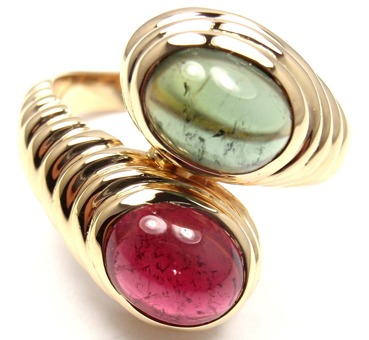 18k Yellow Gold Pink & Green Tourmaline Ring By Bulgari. With 1 Oval Pink Tourmaline 7mm x 10mm and 1 Oval Green Tourmaline 7mm x 10mm

Details:
Ring Size: 8.5 (resize available)
Width: 20mm
Weight: 13.6 grams
Stamped Hallmarks: Bvlgari