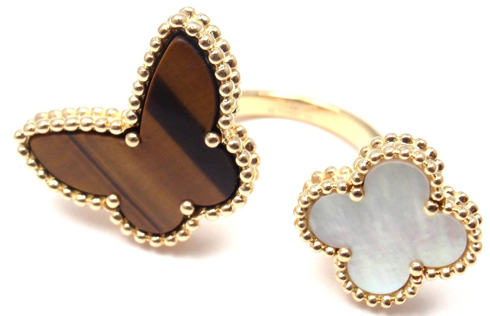 18k Yellow Gold Tigers Eye And Mother Of Pearl  Lucky Alhambra Between The Finger Ring by Van Cleef & Arpels.
With Butterfly shape tiger eye And
Mother of Pearl alhambra

This ring comes with Van Cleef & Arpels box.

Details:
Size - 5 1/4 US,
