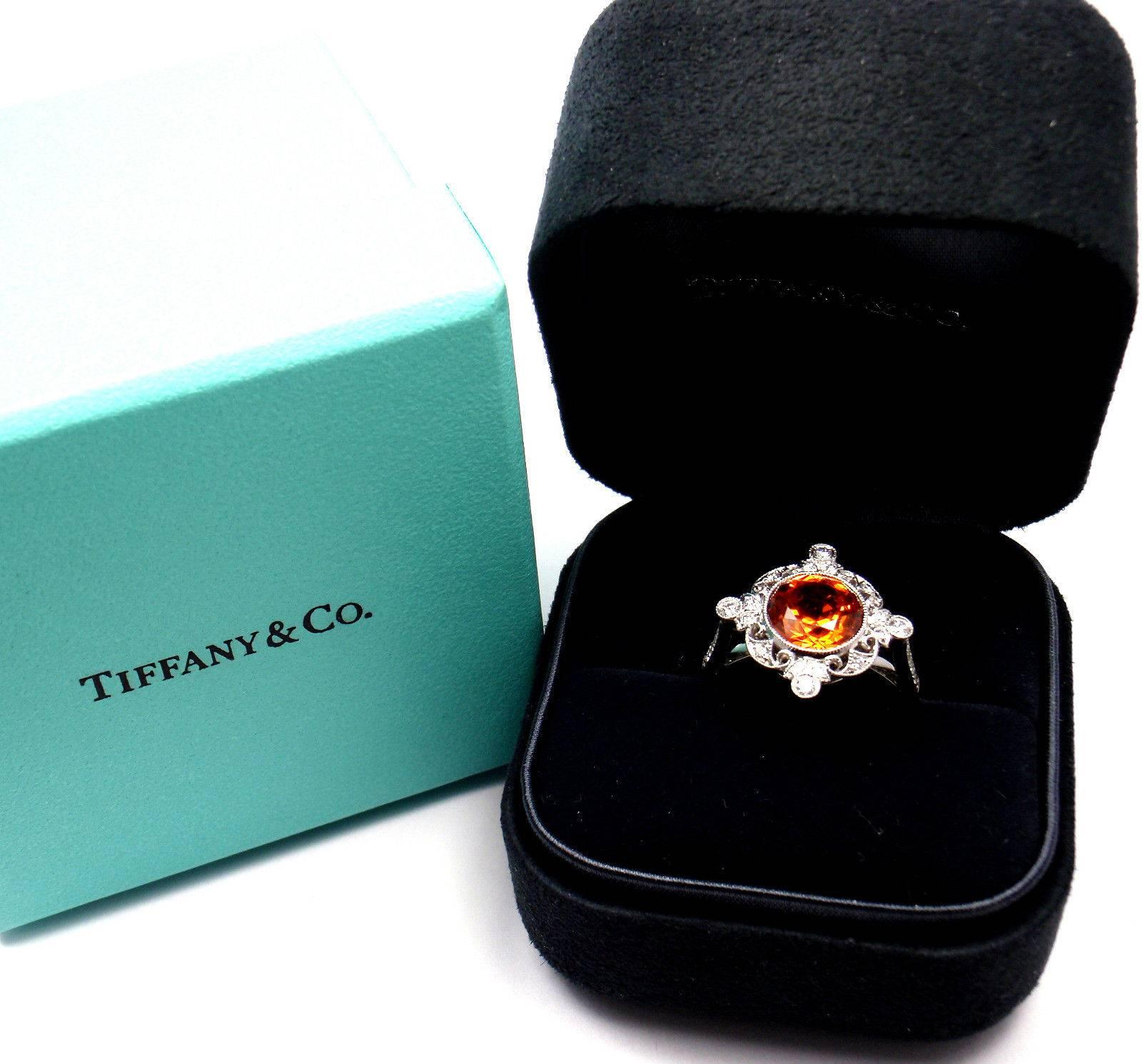 Platinum 3.25ct Spessartite Garnet & Diamond Ring by Tiffany & Co. 
With 1 round Spessartite Garnet 3.25ct
24 round brilliant cut diamonds VS1 clarity, G color total weight approx. .50ct

This ring comes with Tiffany & Co Box and Tiffany & Co