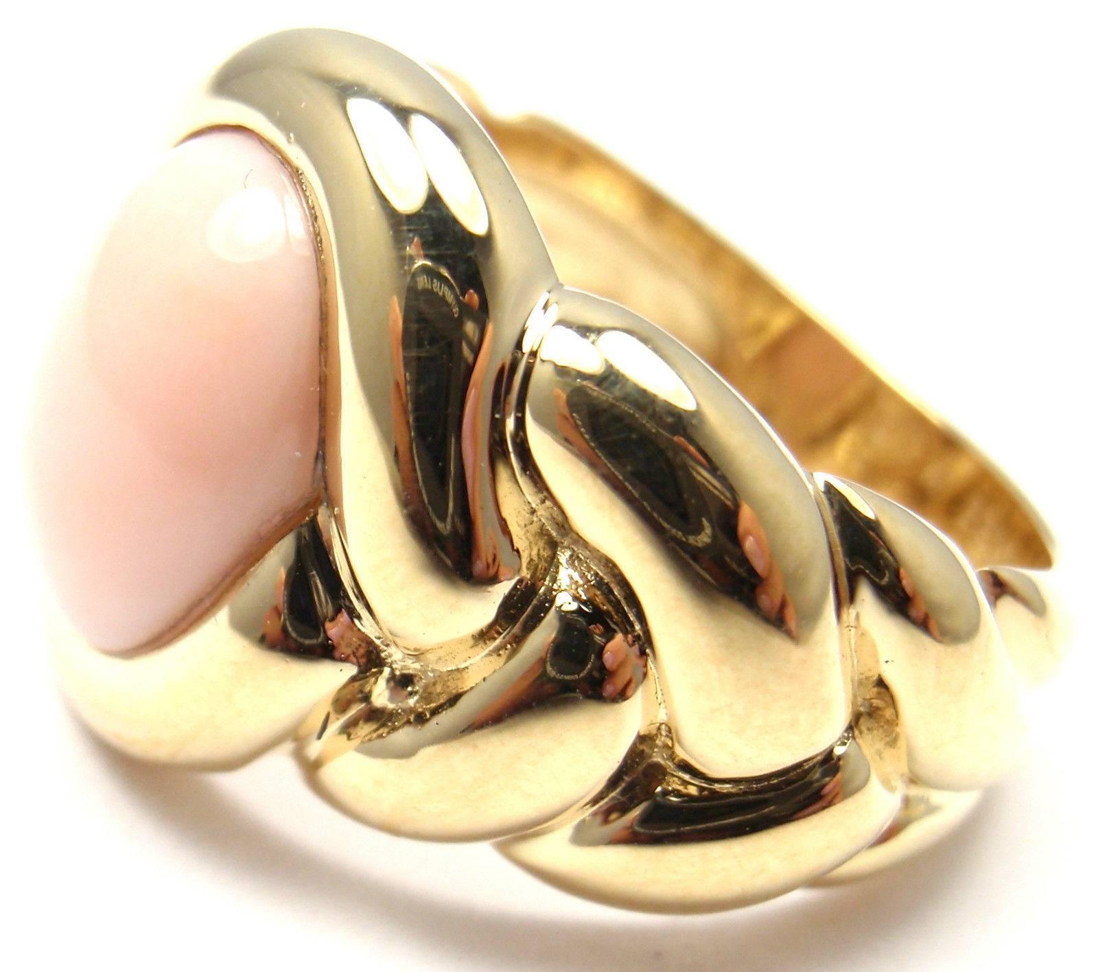 18k Yellow Gold Angel Skin Coral Braided Band Ring by Van Cleef & Arpels. 
With 1 oval angel skin coral 10mm x 8mm

Details: 
Ring Size: 5.5 
Width: 14mm 
Weight: 9.2 grams 
Stamped Hallmarks:  18KT VCA 90 B5368K10

*Free Shipping within