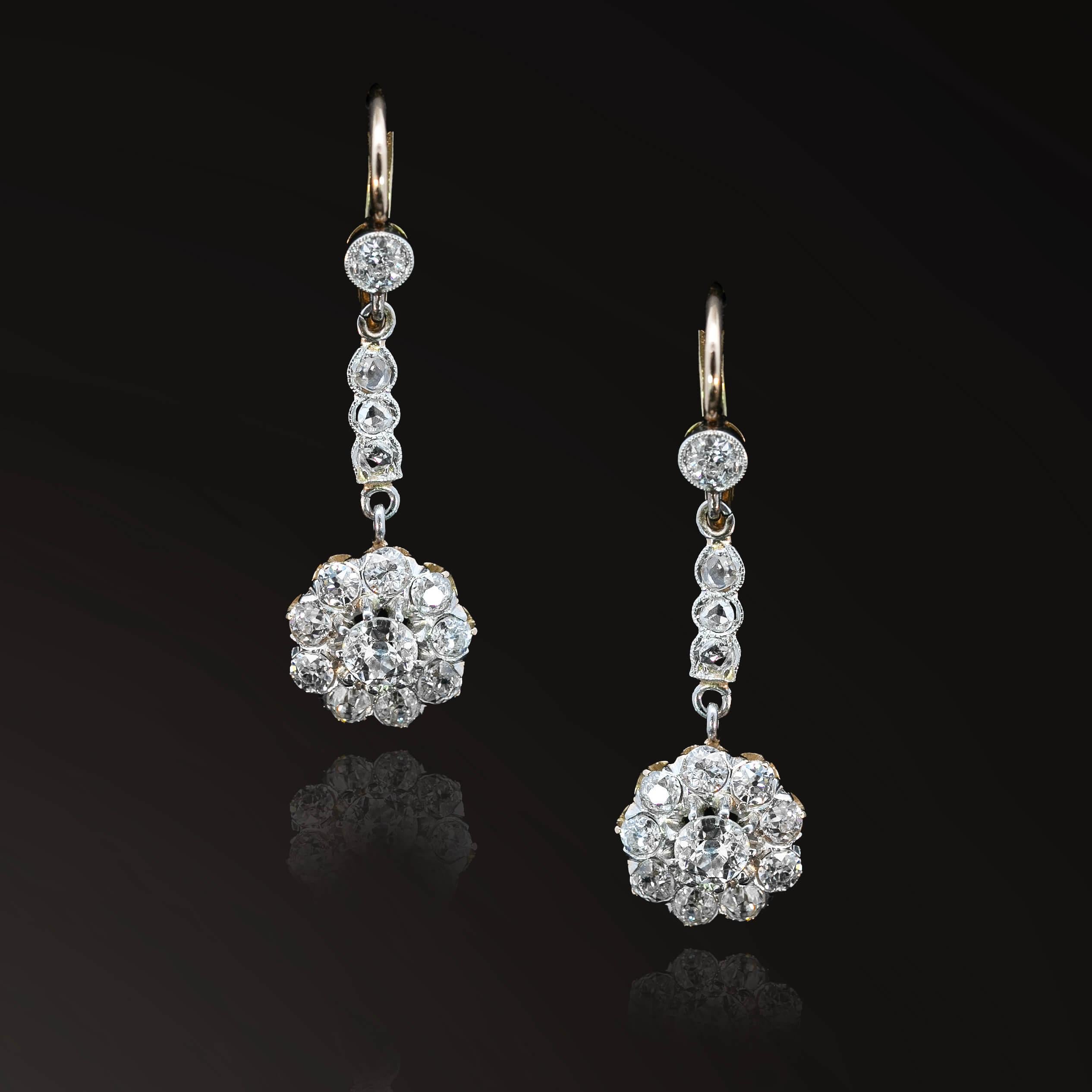 Precioso par de pendientes eduardianos con una gota de diamantes talla rosa sobre un racimo de diamantes de dos hileras en un engaste de galería. Las tres piezas están unidas y suspendidas por anillas cerradas que permiten un sutil movimiento de los