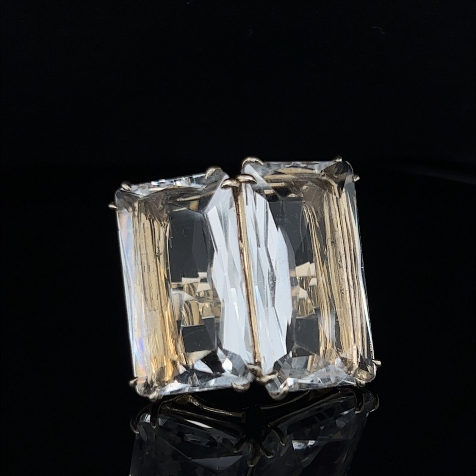 This large authentic and impressive ring is by H.Stern Cobblestone Collection. It is crafted from 18k yellow gold featuring an double frame open bridge set with 2 large rectangle faceted cut clear rock crystal gemstones, these are held securely in 4