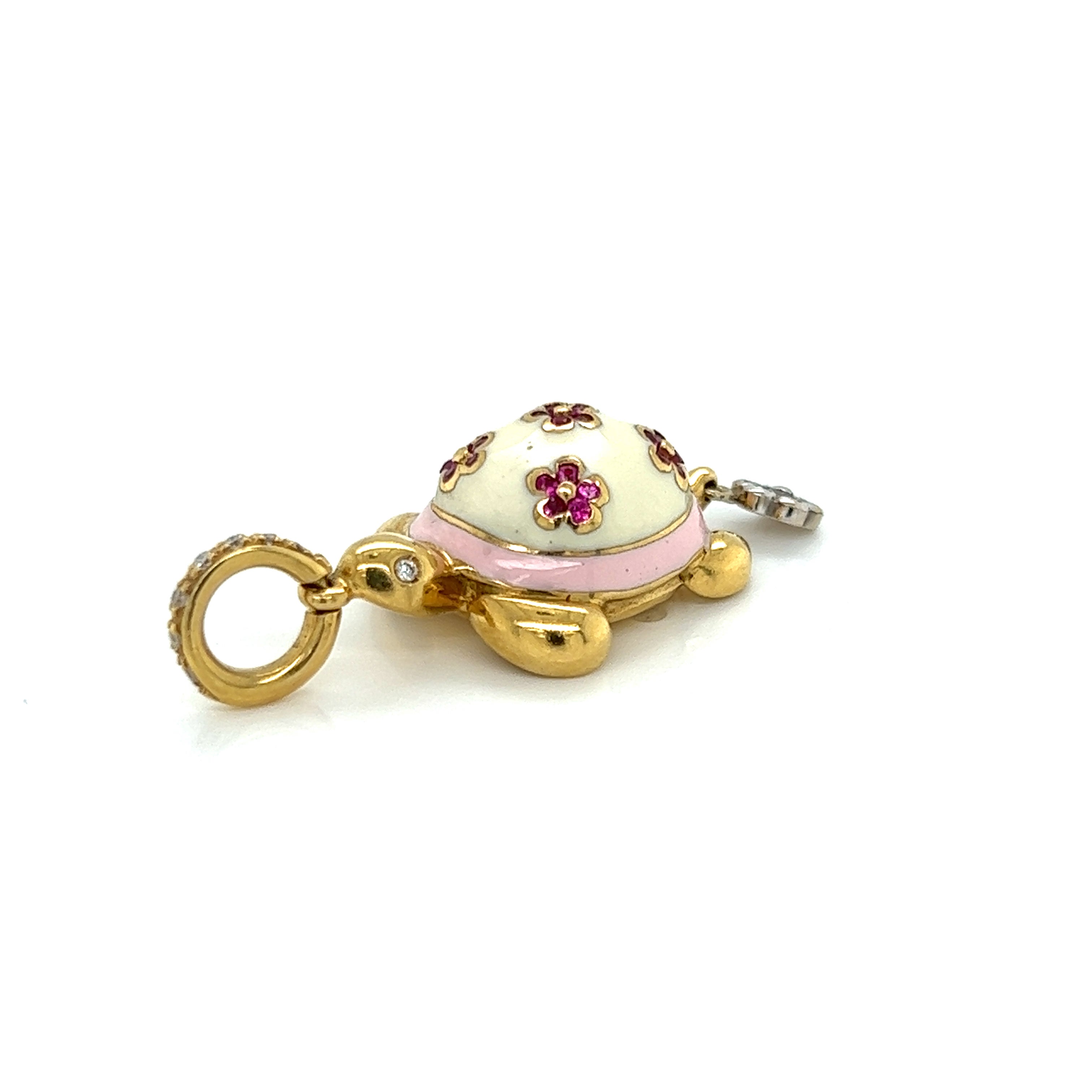 This classic adorable authentic pendant is by Aaron Basha, it is crafted from 18k yellow and white gold featuring a turtle with cream and pink enamel. Its shell is cream enamel with 5 small flowers set with pink sapphires, below the shell is pink