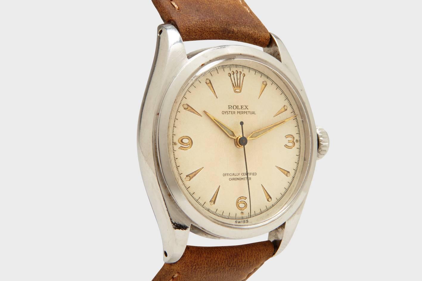 An immaculate and rare stainless steel Rolex Oyster Perpetual with an Explorer style dial. This watch is a very early transitional model as the company stepped away from the smaller, and more bulky sized bubble back models that dominated their