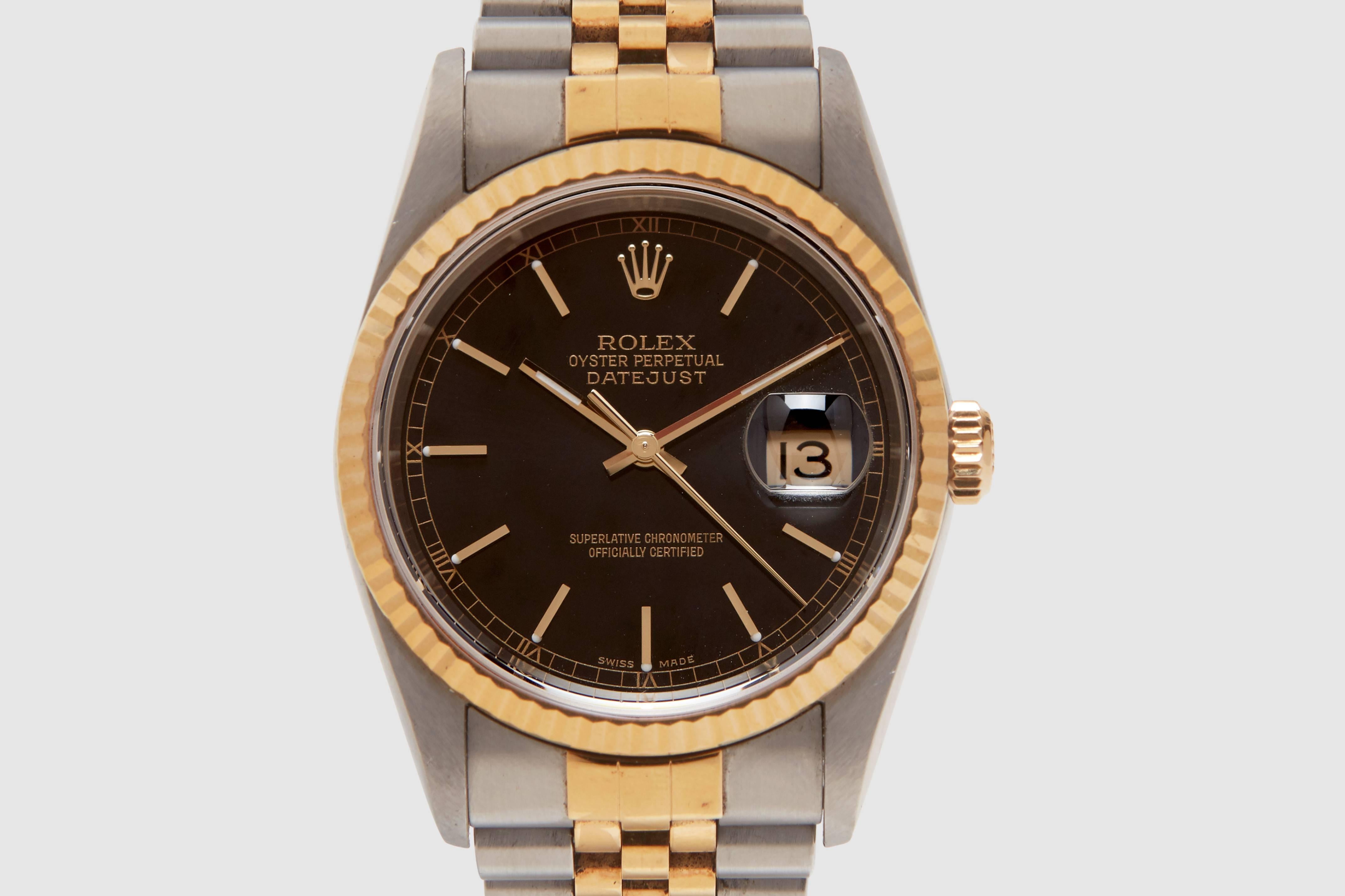 An automatic eighteen carat and stainless steel Rolex Oyster Perpetual Datejust reference 16223 model. This example has a stylish black dial with classic 'stick' markers and a gold print Roman numeral chapter ring running around the edge. 

All