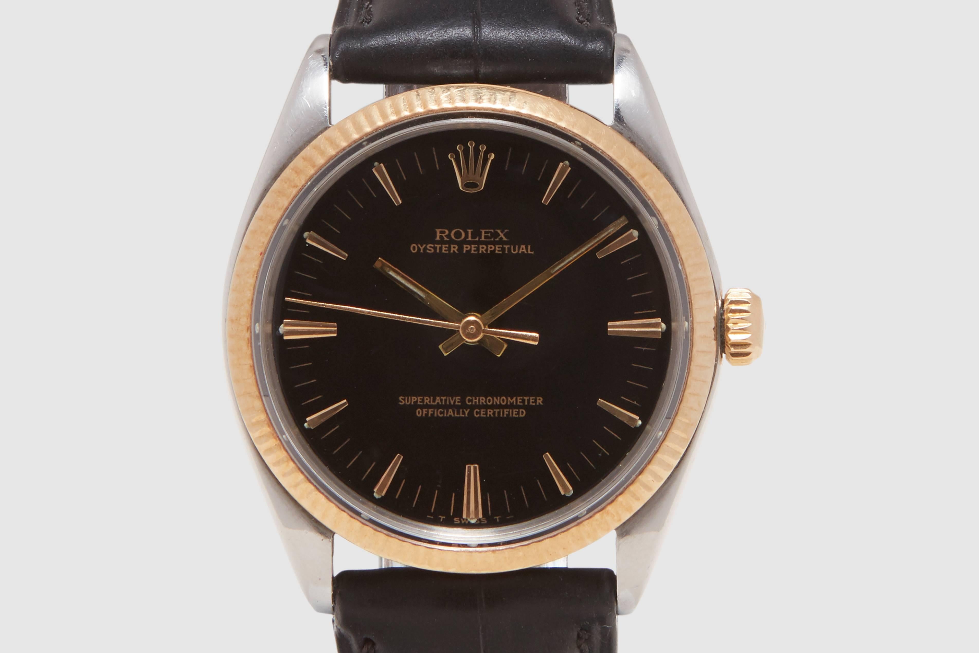 A stainless steel and eighteen carat gold Rolex Oyster Perpetual. This is somewhat of an unusual reference for Rolex, the '1005'. This is essentially a Rolex Oyster Perpetual Date case and movement, except the date window at the three o'clock