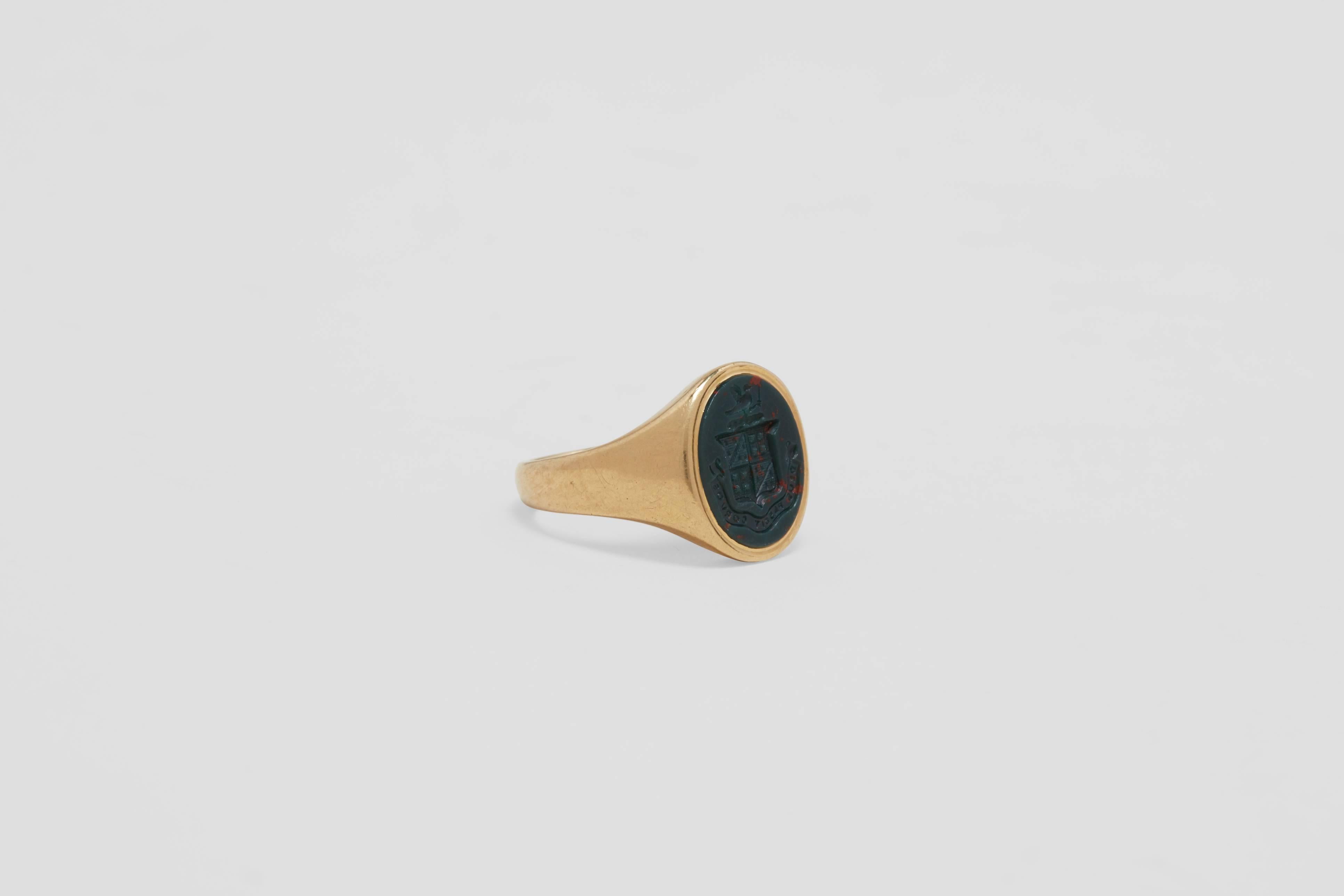 A solid eighteen carat gold gentleman's signet ring with a classic oval shaped, heraldic hand carved, bloodstone.  This iconic style ring, worn by noblemen and kings for centuries, is made in eighteen carat yellow gold.

A classic signet ring