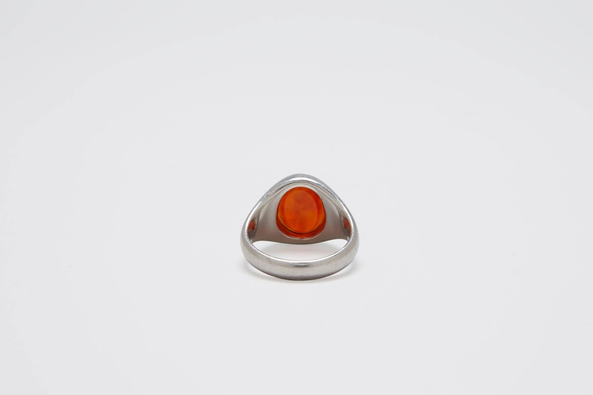 Stunning and rare solid platinum signet ring with carved carnelian stone set in the center.  A classic design, beautiful proportions and has a lovely patina to the metal. 