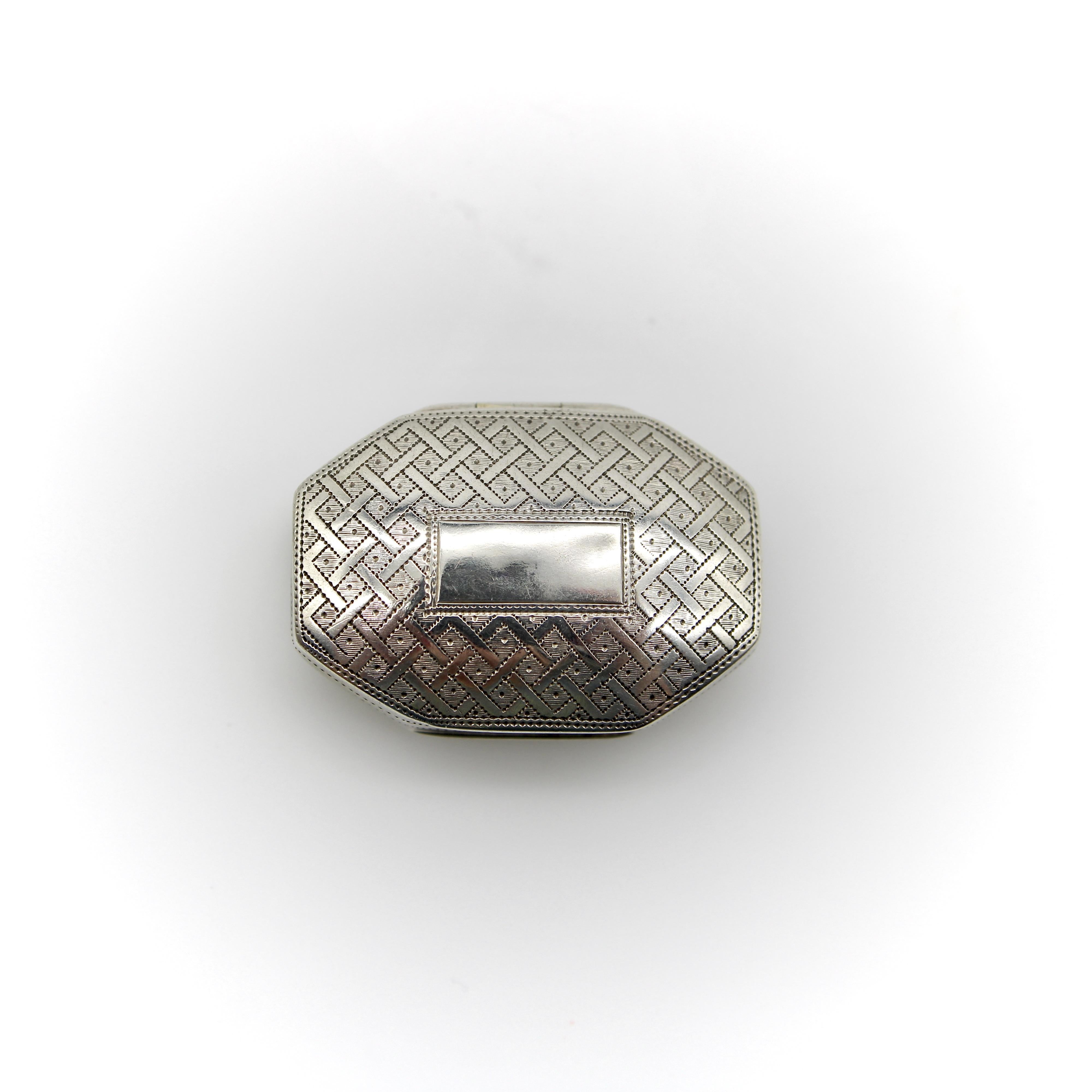 Circa 1816, this sterling silver vinaigrette is octagonal, with convex top and bottom lids, giving it a nice rounded shape. The top of the box is engraved with a latticework design, and the bottom of the vinaigrette is engraved with a flower that