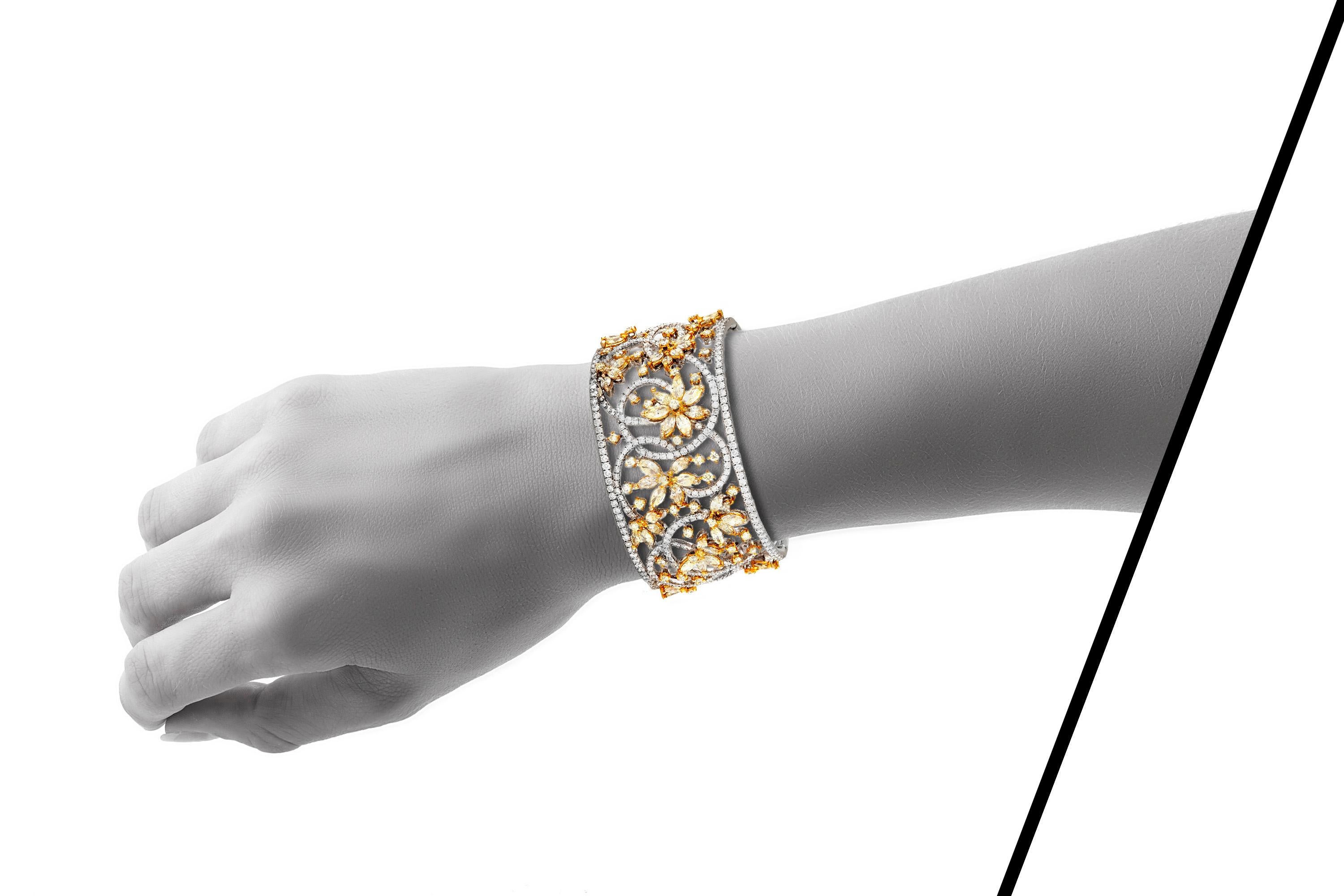 Cuff bracelet, finely crafted in 18 k white gold with marquise and brilliant cut, fancy yellow diamonds and white brilliant cut diamonds, weighing a total of approximately 13.30 carats.
