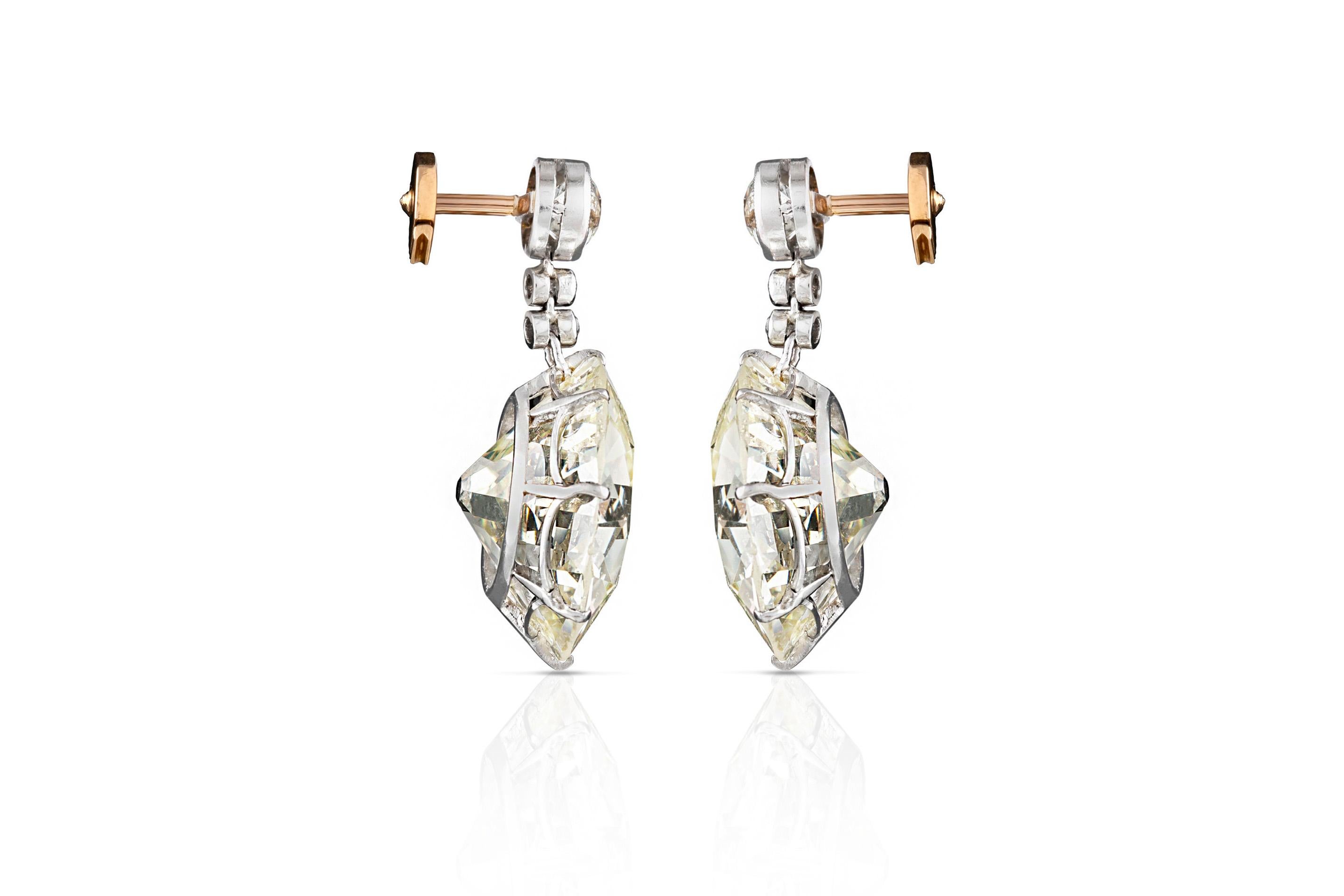 Antique, Edwardian diamond, drop earrings, finely crafted in platinum and 18 k yellow gold, featuring 15.88 carat and 15.95 carat, Old European cut diamonds at the bottom. Circa 1910's.