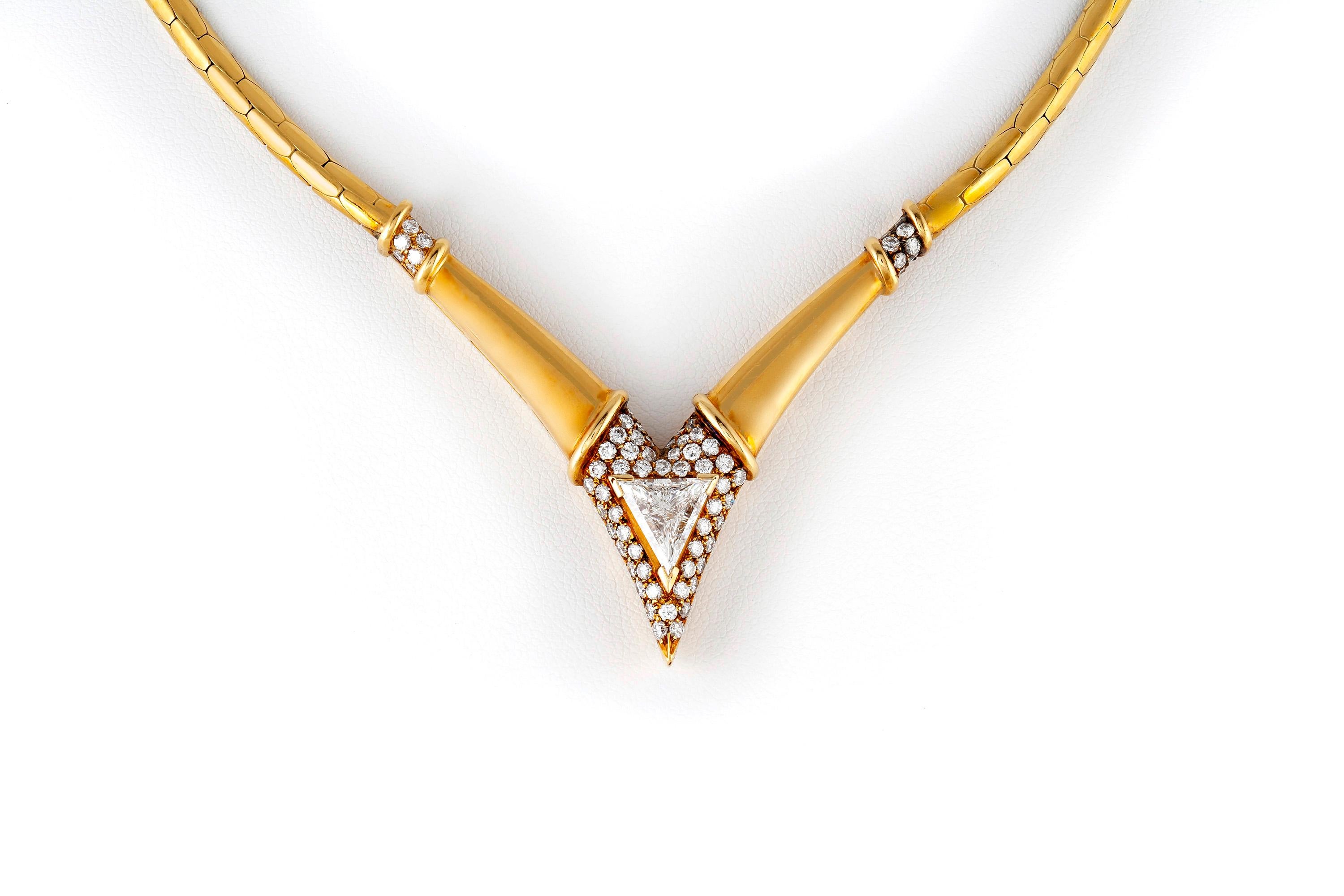 Vintage necklace, finaley crafted in 18k yellow gold, featuring trillion cut diamond weighing approximately 1.80 carats and brilliant cut diamonds, weighing a total of approximately 2.25 carats. 
Circa 1980's. 
