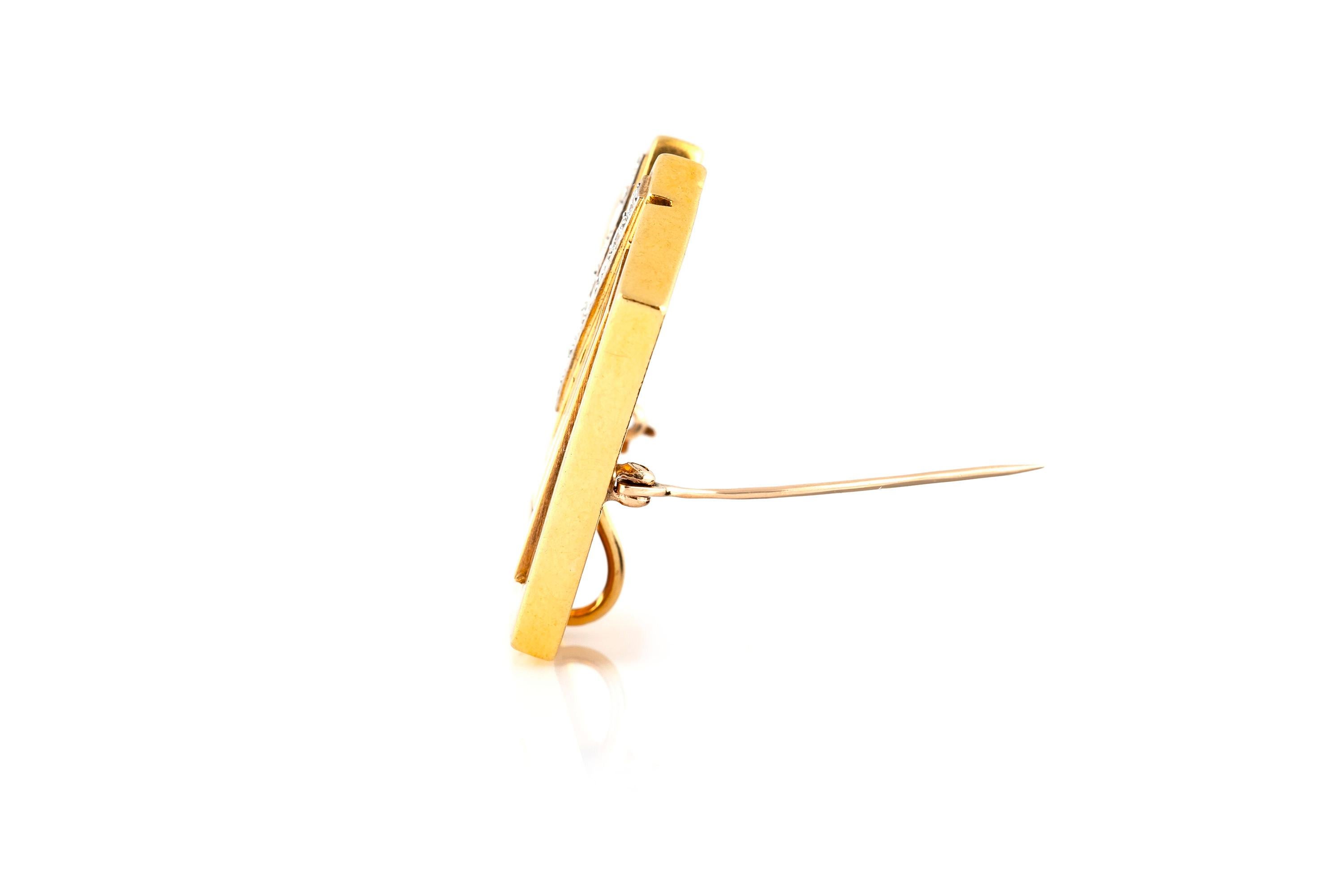 Signed Cartier 18K yellow gold pin with diamonds at the center weighing approximately 0.90 carat. 