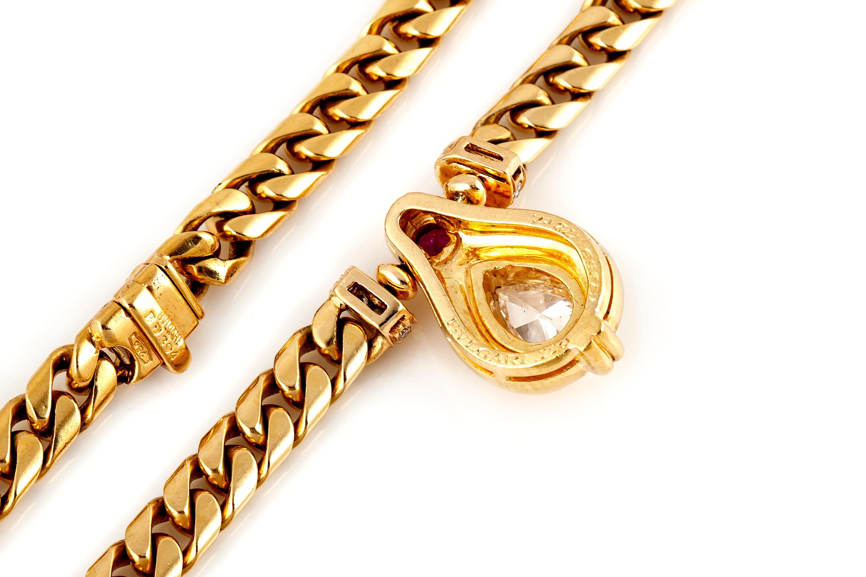 Bvlgari necklace, finely crafted in 18 k yellow gold, featuring pear shaped diamond at the center, weighing 0.73 carat, accented with round ruby and brilliant cut diamonds. Circa 1980's.