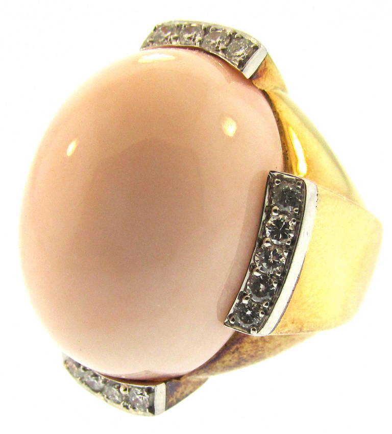 David Webb Angelskin Coral and Diamond Cocktail Ring
Large Angelskin Coral Dome set in 18Kt Gold
With Pave Diamonds 
Signed David Webb
American
Circa 1960