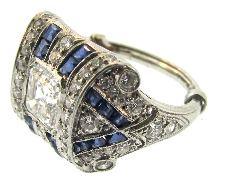 Tiffany & Co Art Deco Sapphire and Diamond Ring
Approximately 1.00 Ct Asher Cut Center Stone
Surrounded by Sapphires and Diamonds
All original to the piece
Mounted in Platinum
Signed Tiffany & Co.
American
Circa 1920