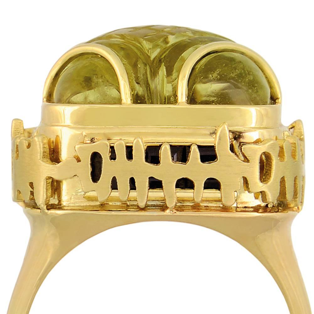 18ct yellow gold, lemon quartz and black sapphire ring
One-of-a-kind
UK Size O/P. Can be adjusted to any ring size.

The stunning and one-of-a-kind ring Calligraphy Ring is set with a large, carved lemon quartz cabochon and inlaid with channel-set