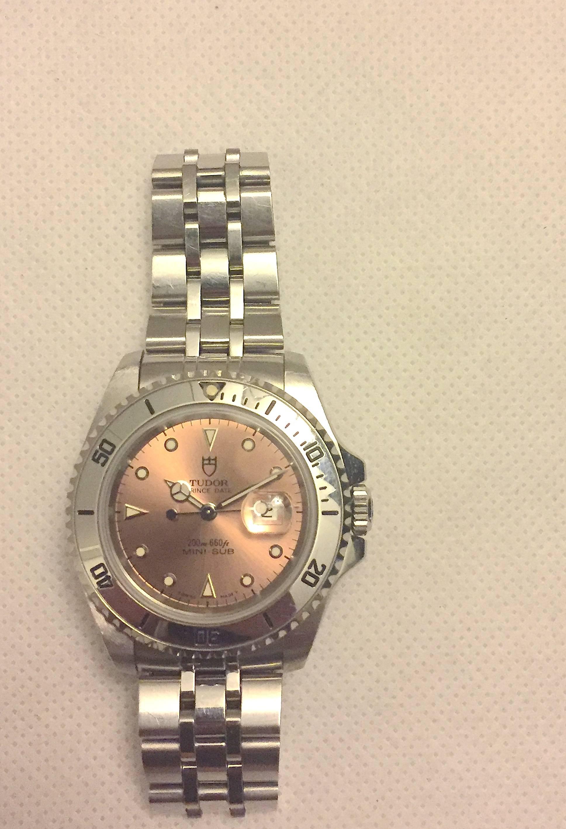 Tudor Prince Stainless Steel Mini Sub Automatic Wristwatch
Factory Salmon Colored Dial with Applied Hour Markers
Uni-Directional Rotating Bezel
35mm in size 
Tudor Automatic Movement
Sapphire Crystal
Late 1990's Production
Fits Up to a 6"