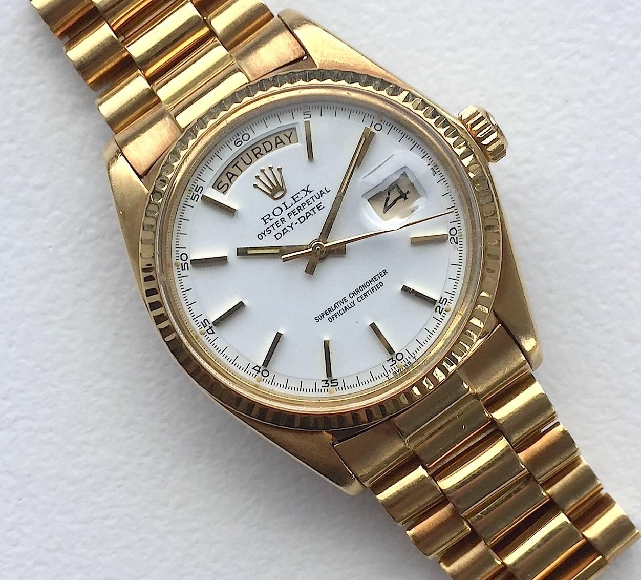 Rolex 18K Yellow Gold Day-Date Presidential Watch from the 1970's
Beautiful Factory White Dial with Applied Yellow Hour Markers and Minute Track Around Perimeter
Yellow Gold Gold Fluted Bezel
18K Yellow Gold Case
36mm in size 
Features Rolex