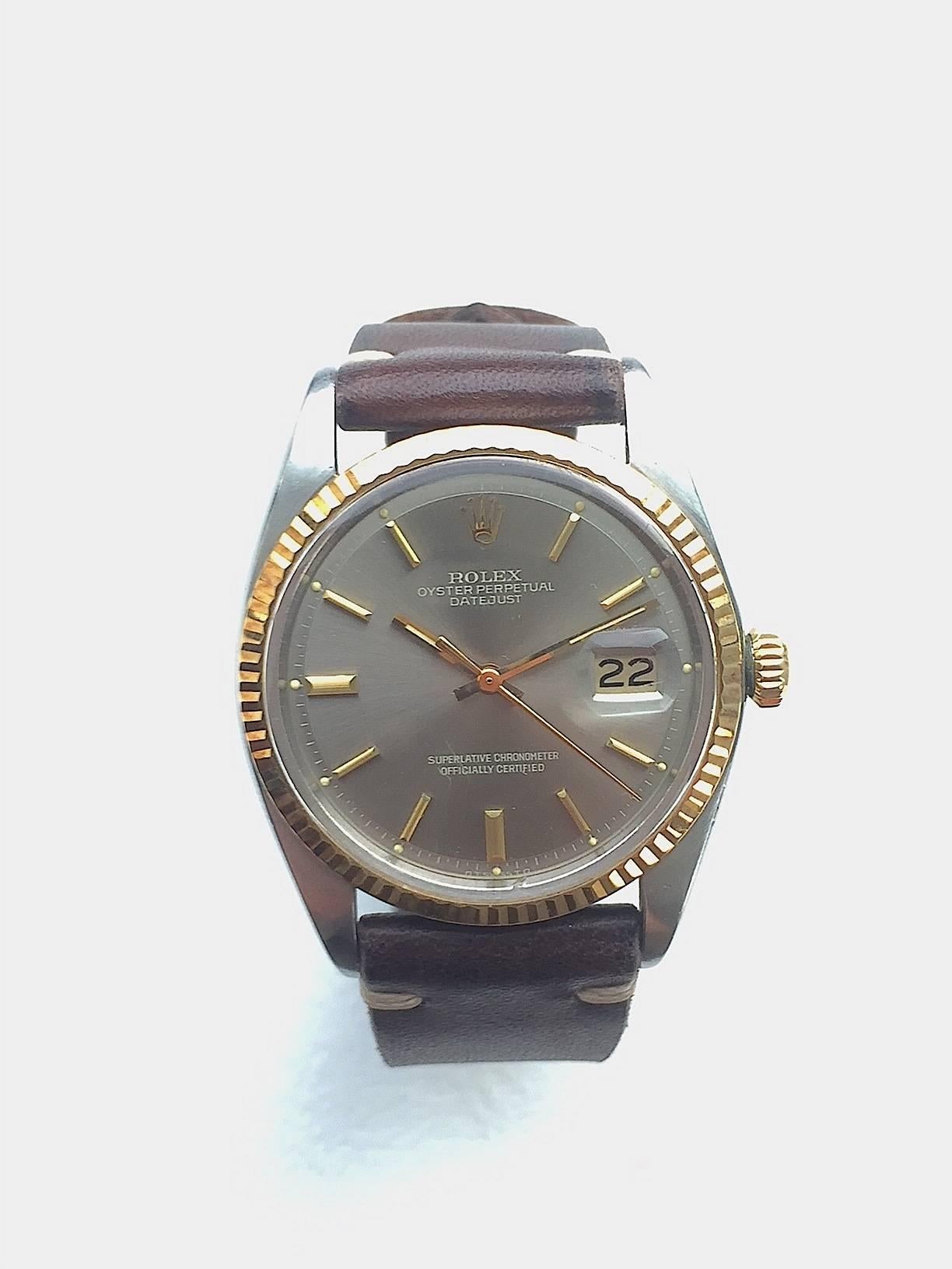 Rolex Stainless Steel and Yellow Gold Oyster Perpetual Datejust Wristwatch
Beautiful Factory Grey Sigma Dial with Yellow Gold Applied Hour Markers
Yellow Gold Gold Fluted Bezel
18K Yellow Gold Case
36mm in size 
Features Rolex Automatic Movement