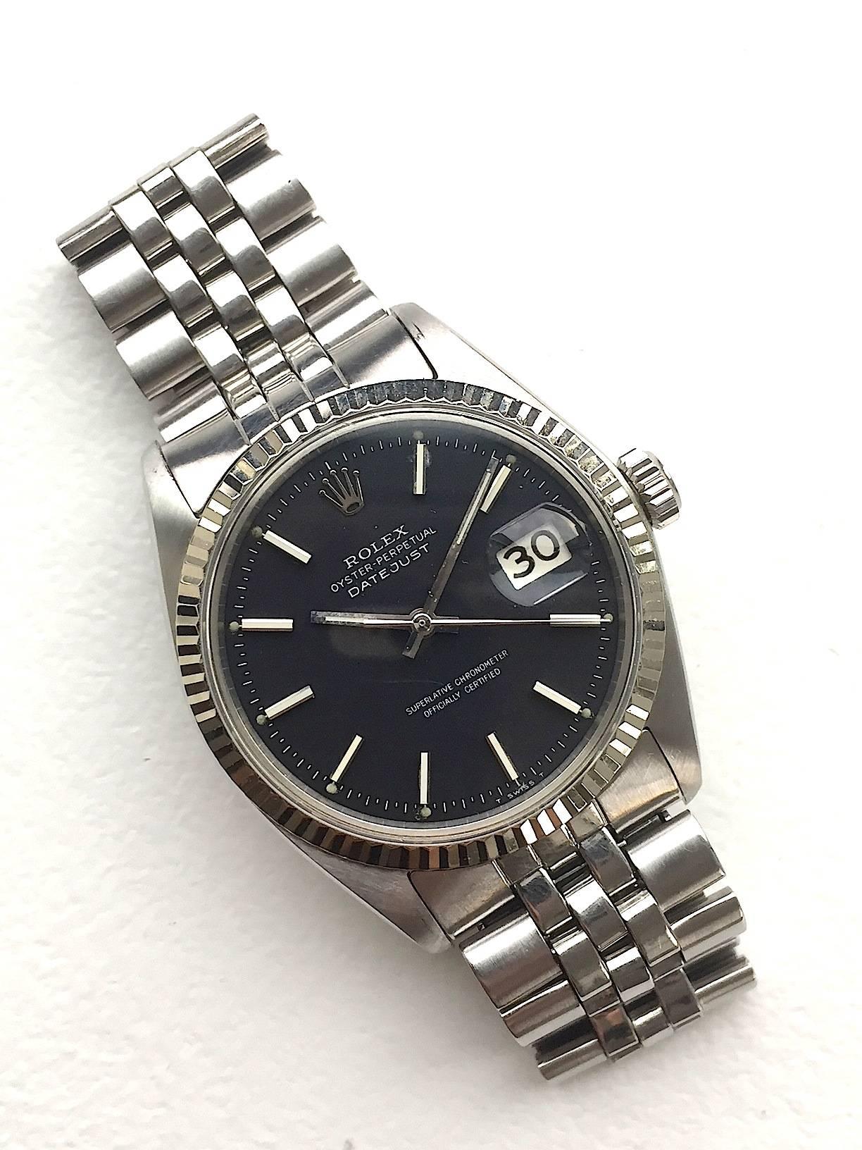 Rolex Stainless Steel and 18K White Gold Oyster Perpetual Datejust Watch
Beautiful Factory Black Matte Dial with White Applied Hour Markers
18K White Gold Fluted Bezel
Stainless Steel
36mm in size 
Features Rolex Automatic Movement with Calibre 1570