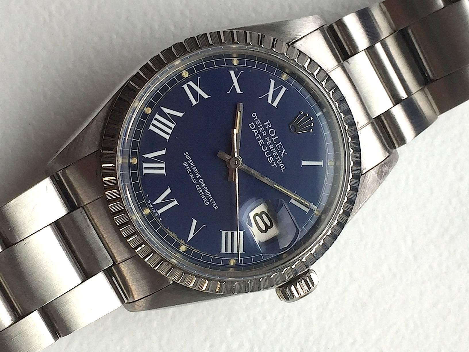 Rolex Stainless Steel Oyster Perpetual Datejust Watch
Factory Blue Buckley Dial with White Roman Numeral Hour Markers
Stainless Steel Engine-Turned Bezel
Stainless Steel Case
36mm in size 
Features Rolex Automatic Movement with Calibre 1570 with