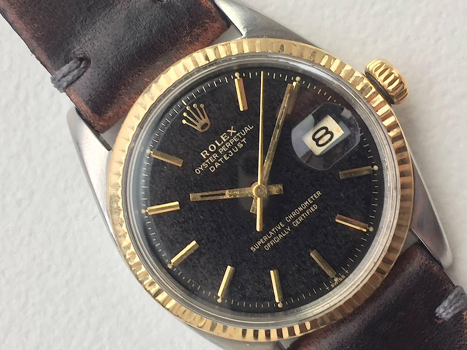 
Rolex Stainless Steel and Yellow Gold Oyster Perpetual Datejust Watch
Factory Black Gilt Gold Writing Dial with Tropical Texture Which Has Aged To This Unique Look
Yellow Gold Gold Fluted Bezel
Stainless Steel Case
Hands Are Missing Luminous From