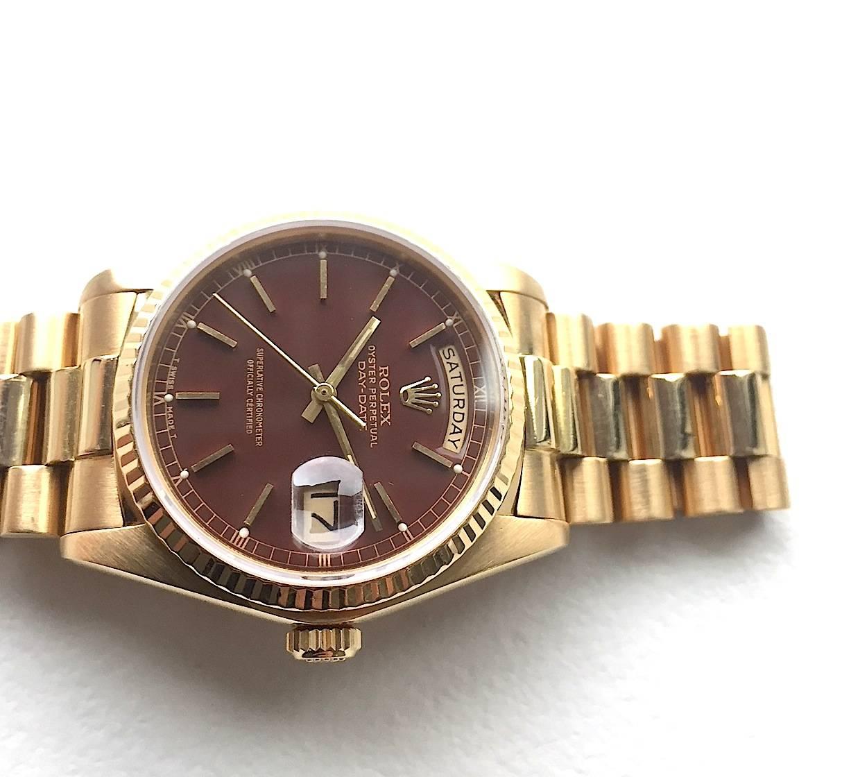 Rare and Pristine Rolex 18K Yellow Gold Day-Date Presidential Watch with Factory Maroon/Oxblood Stella Dial
Beautiful Factory Oxblood Red Dial with Minute Track and Applied Gold Hour Markers
Yellow Gold Gold Fluted Bezel
18K Yellow Gold Case
36mm in
