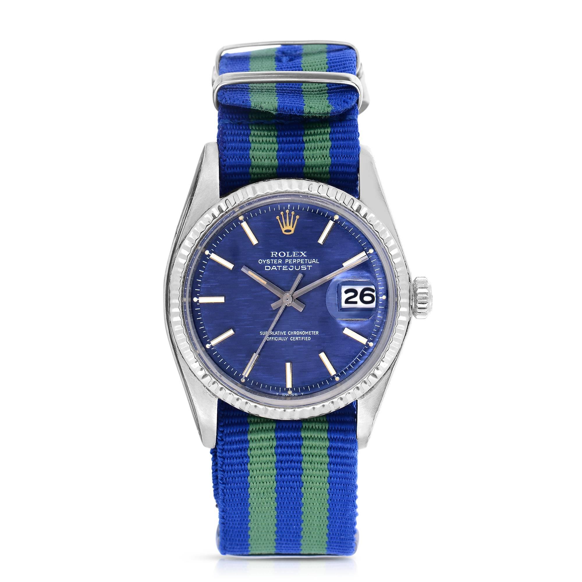 Vintage Rolex Oyster Perpetual Datejust
36mm in size
Stainless Steel Case
18K White Gold Case
Rare Blue Linen Dial
Date function at three o'clock
Blue and Green Striped Nato Nylon Strap
Acrylic Crystal
Screw Down Crown
One Year Warranty on