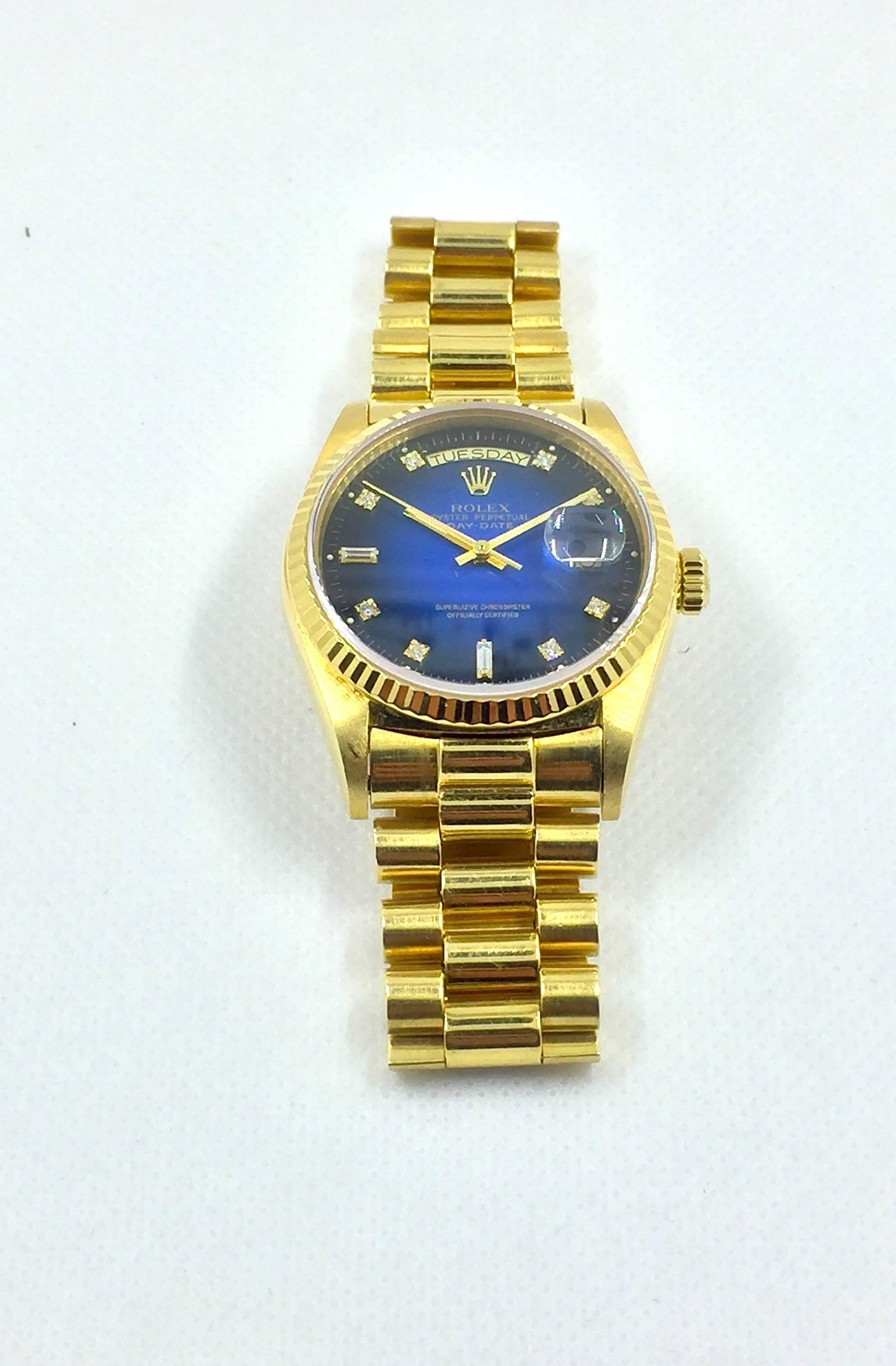 Vintage Rolex Oyster Perpetual Day-Date Presidential Watch
18K Yellow Gold Case and Bracelet
Rare Factory Blue Vignette Degrade Diamond Dial
Day and Date Functions
18K Yellow Gold Rolex Presidential Bracelet
Sapphire Crystal
Features Original