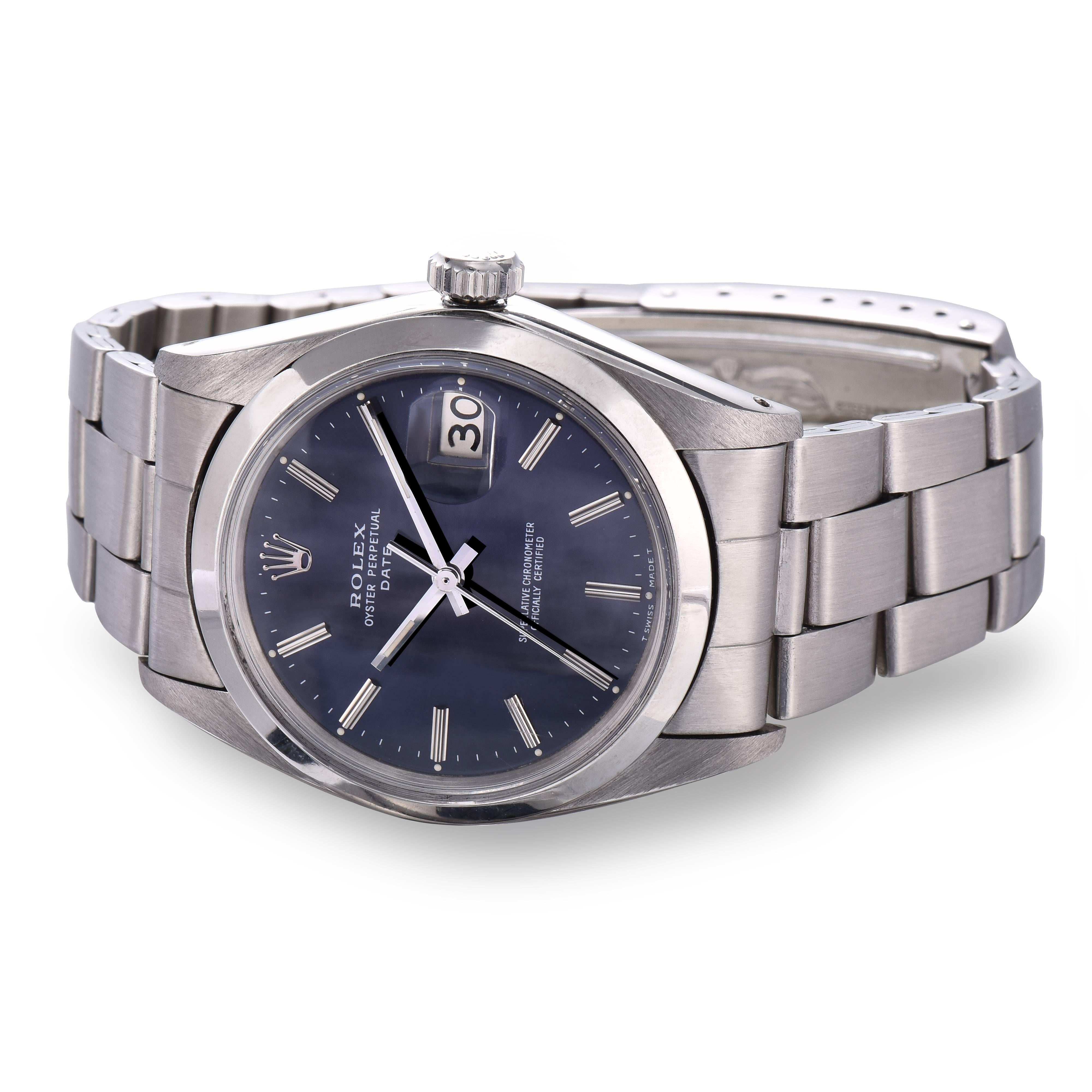 Rolex Stainless Steel Oyster Perpetual Date Watch
Dark Blue/Grey Dial with Silver Applied Hour Markers
Stainless Steel Case
34mm in Size 
Rolex Stainless Steel Screw Down Crown
Plastic Crystal
From 1968
Comes Fitted on a Rolex Stainless Rivet