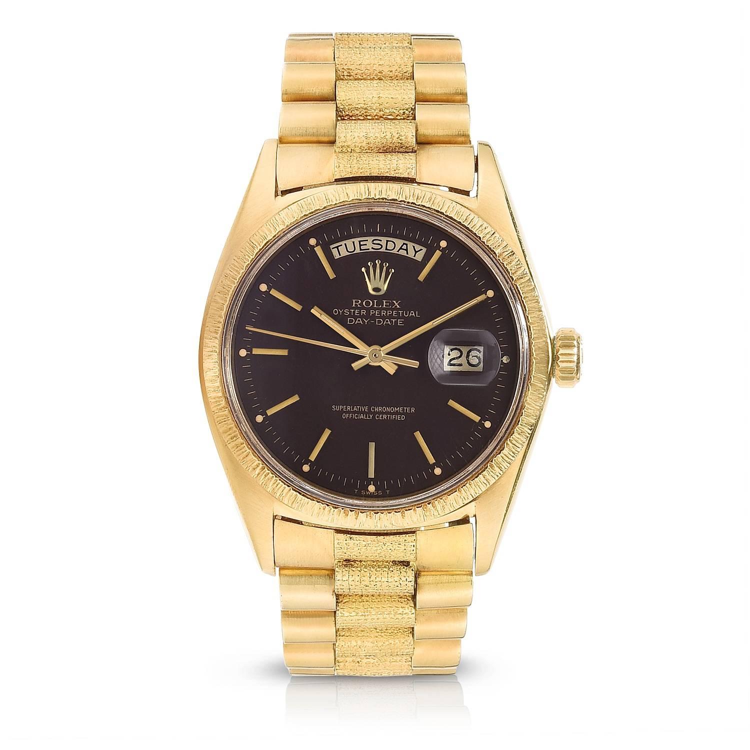 Rolex 18K Yellow Gold Oyster Perpetual Day-Date Presidential Wristwatch
Factory Brown Matte Dial
Rare Reference 1807 with Factory Finish
18K Yellow Gold Bezel with Bark Finish
36MM in Size 
Rolex Calibre Base 1500 Automatic Movement
Acrylic