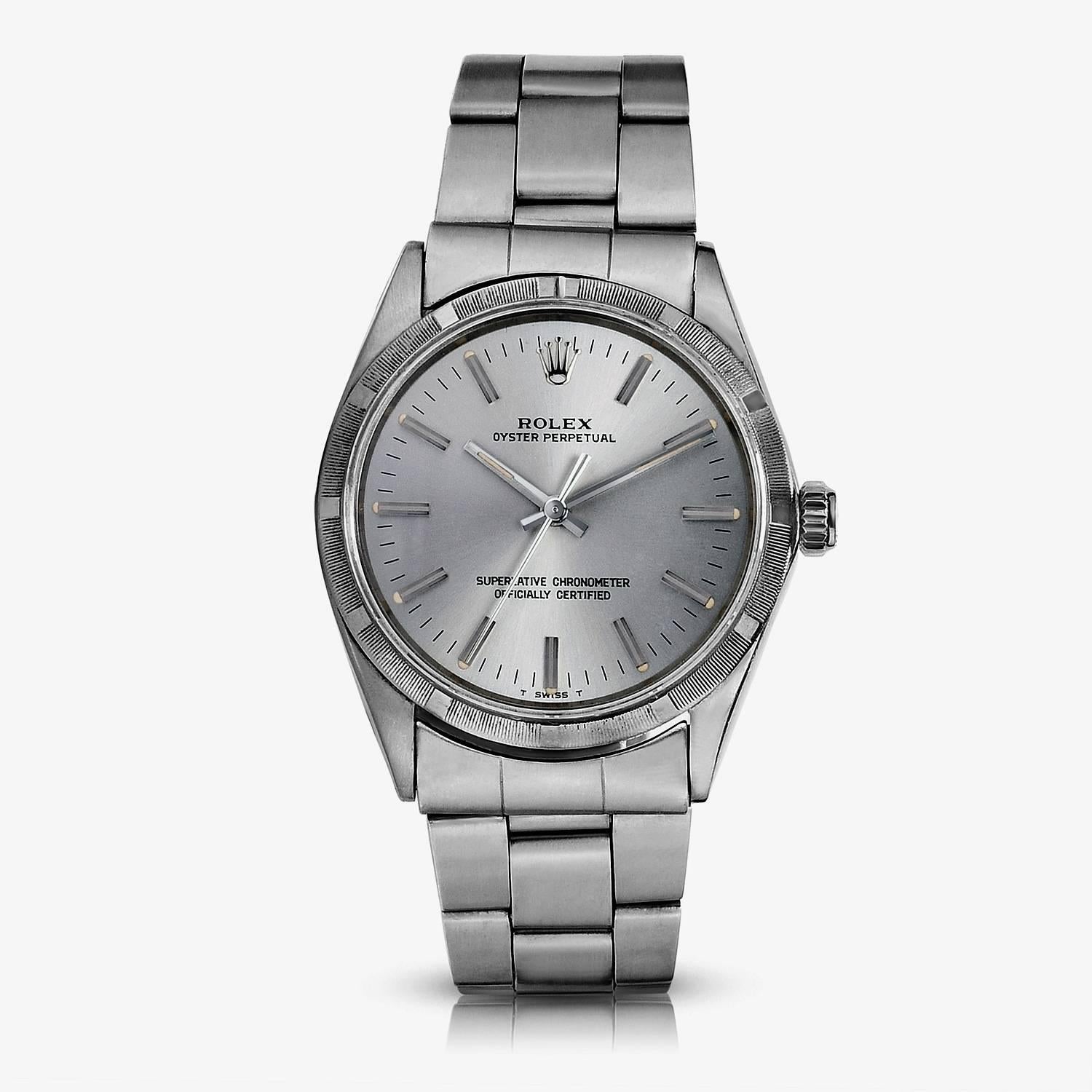 Rolex Stainless Steel Oyster Perpetual Wristwatch
Factory Silver/Grey Dial
Stainless Steel Engine-Turned Bezel
34mm in size 
Rolex Automatic Movement
Acrylic Crystal
Late 1960s Produciton
Comes Fitted on Original Rolex Stainless Steel Folded Link