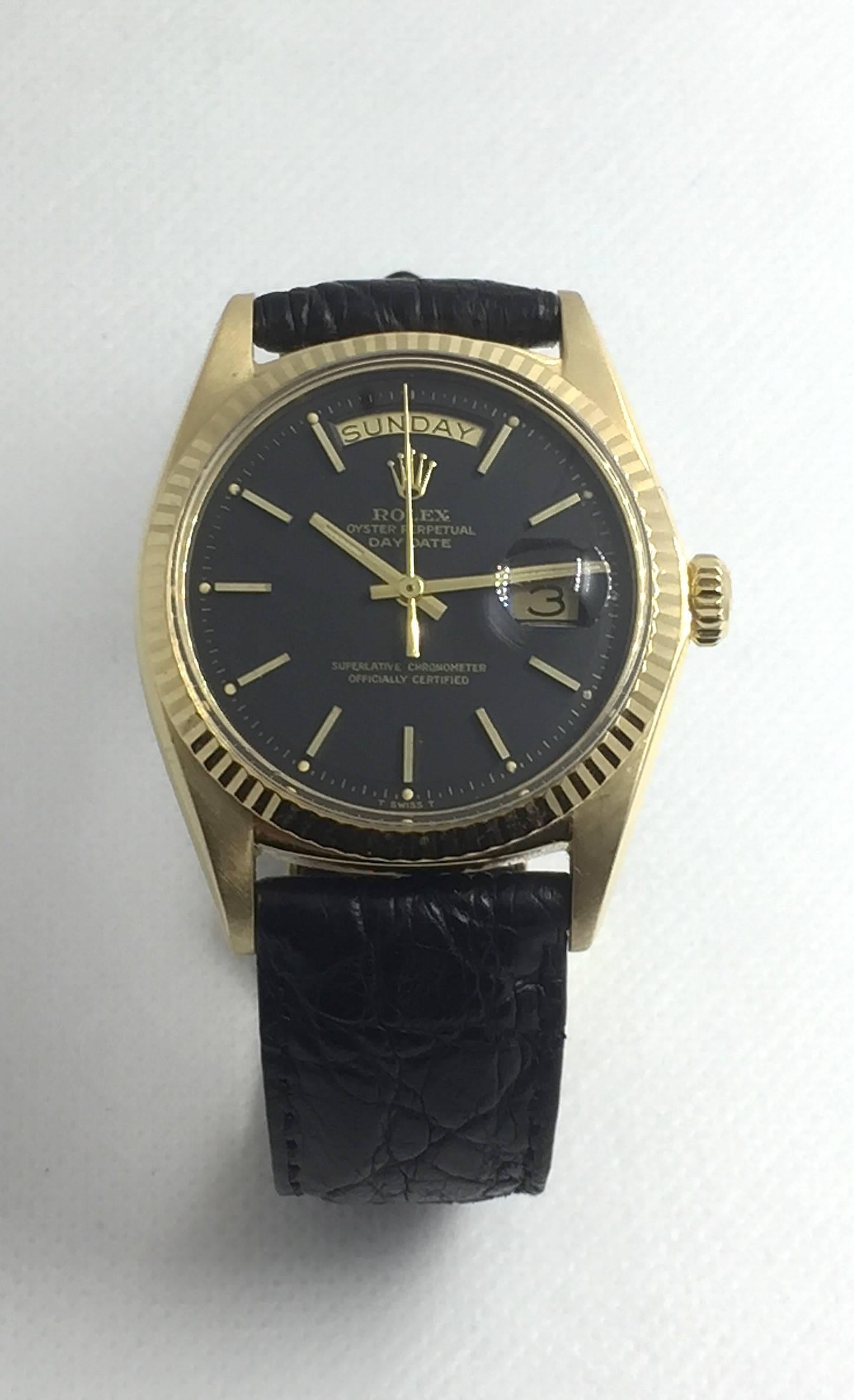 Rolex Yellow Gold 18K Oyster Perpetual Day-Date Presidential Wristwatch
Factory Black Pie-Pan Dial with Applied Hour Markers
18K Yellow Gold Fluted Bezel
36mm in size 
Rolex Calibre Base 1500 Automatic Movement
Day and Date Functions
Acrylic