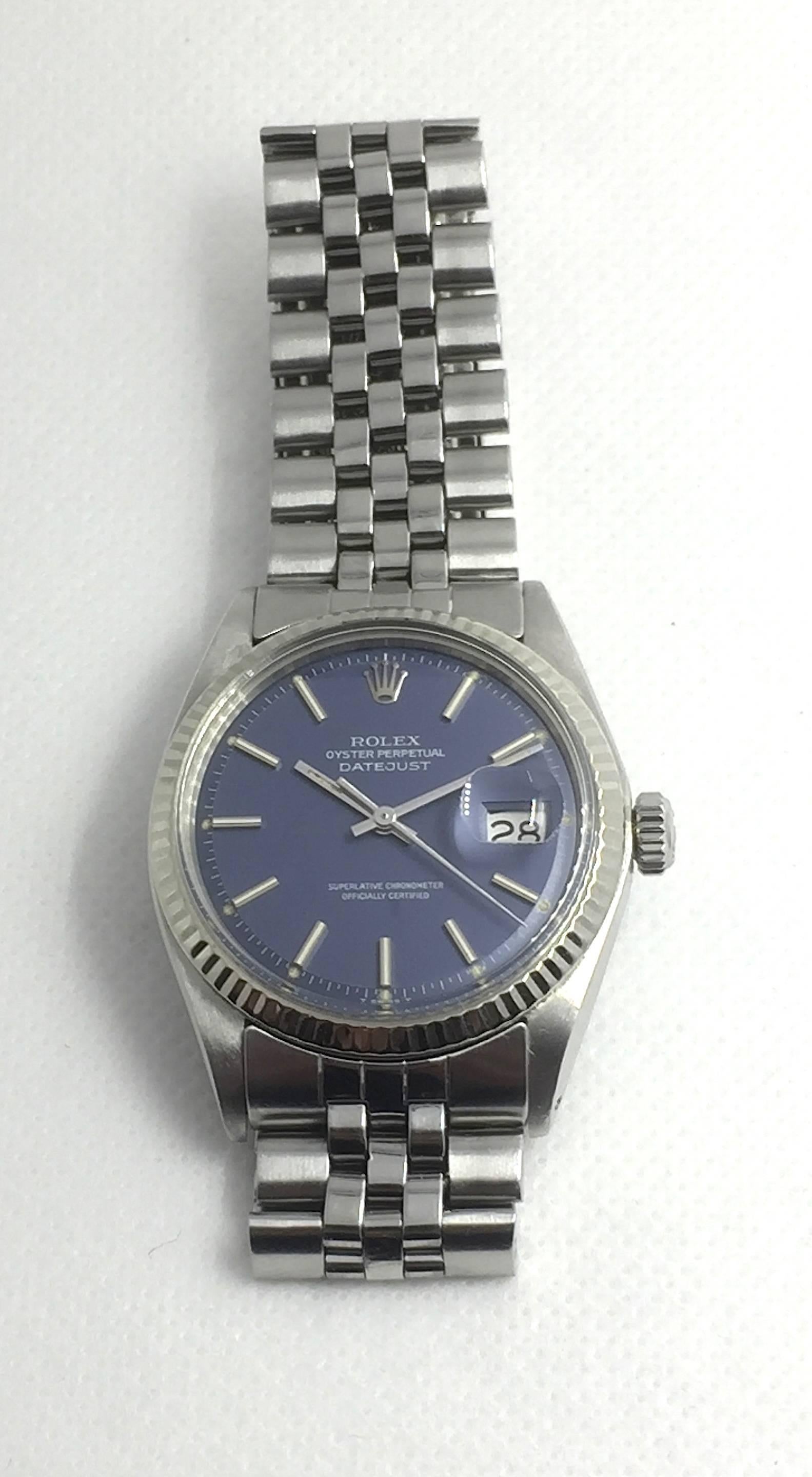 Rolex Stainless Steel Oyster Perpetual Datejust Wristwatch
Factory Blue Matte Dial with Silver Applied Hour Markers
White Gold Fluted Bezel
36mm in size 
Rolex Calibre Base 1500 Automatic Movement
Acrylic Crystal
Early 1970s Production
Comes Fitted